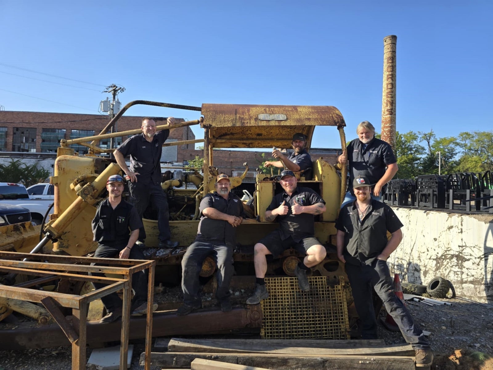 Tractor house employees on an old tractor